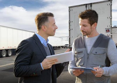 Two business professionals discussing semi-trailer rentals in Los Angeles for flexible leasing solutions.